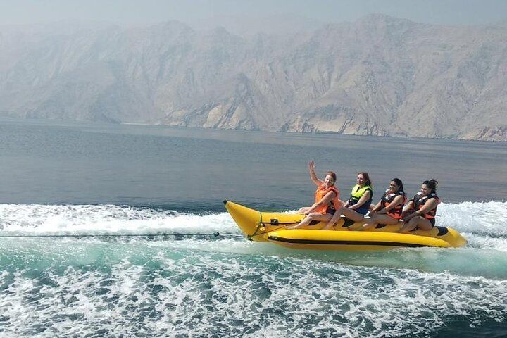 Experience the thrill of the banana boat ride amidst stunning landscapes perfect for creating unforgettable memories while enjoying the warm waters of the Musandam Dibba coastline.